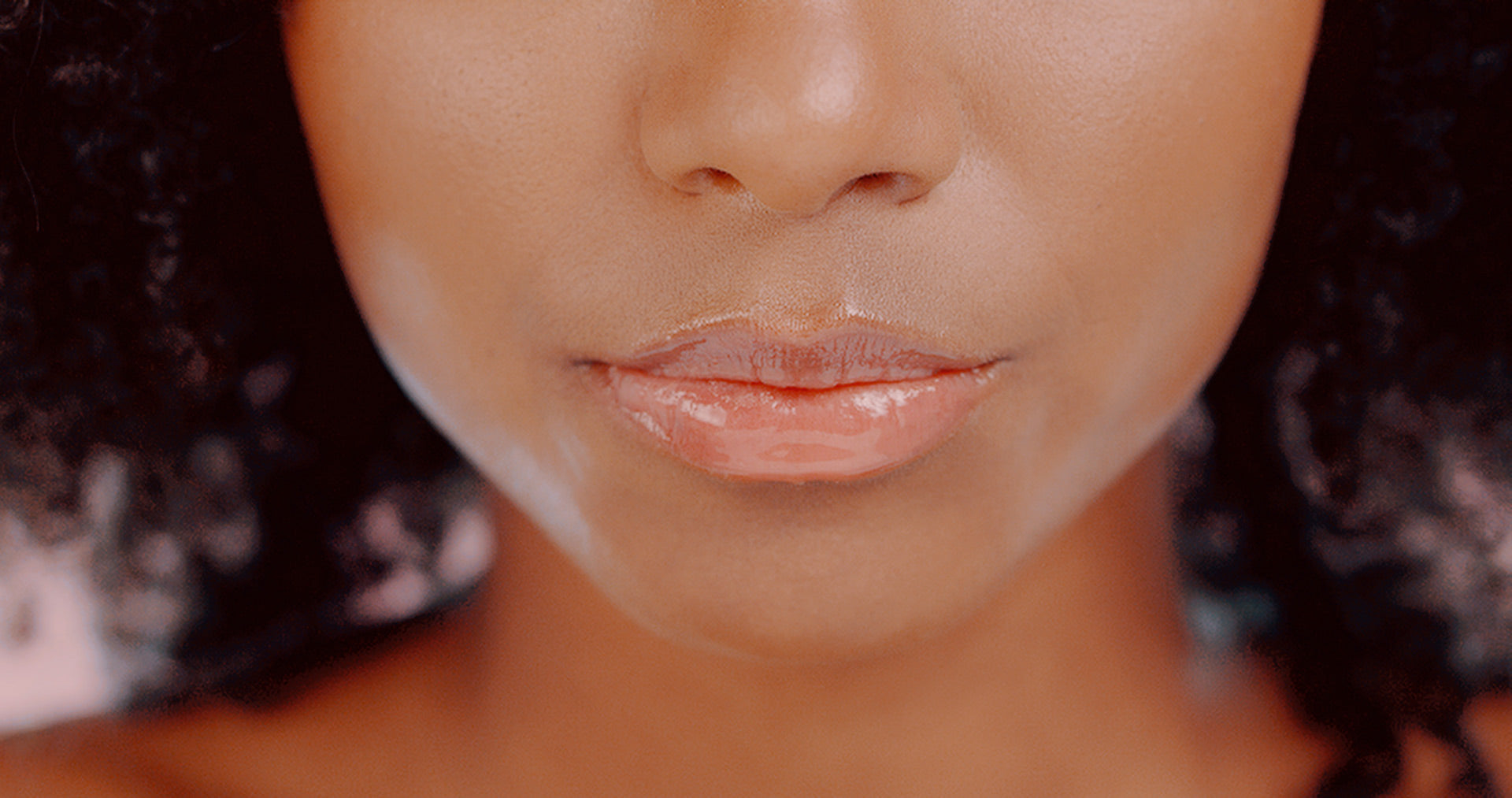 Woman wearing L'Oreal Infallible Pro Gloss Plump in shade 601 Rosy Flush showing glossy plumped lips
